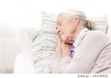 happy senior woman sleeping on pillow at home happy senior woman sleeping on pillow at home 20109305