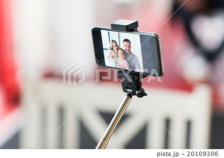 close up of happy family selfie on smartphone close up of happy family selfie on smartphone 20109306