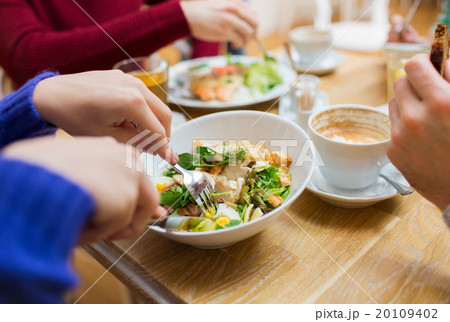 close up friends having dinner at restaurant 20109402
