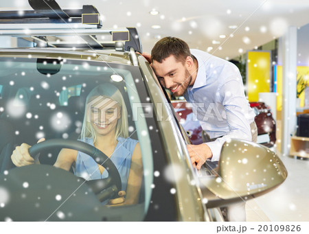 happy couple buying car in auto show or salon 20109826