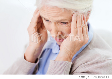 face of senior woman suffering from headache face of senior woman suffering from headache 20109831