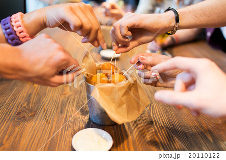 close up of people hands taking cheese balls 20110122