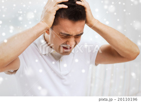 unhappy man suffering from head ache at home 20110196