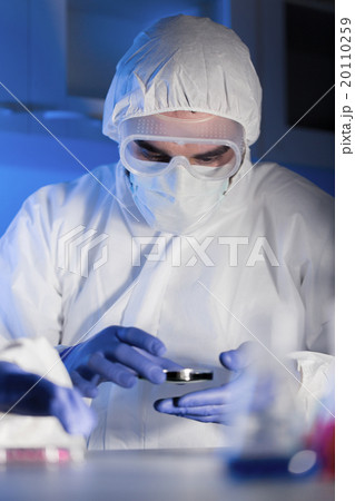 close up of male scientist with test sample in lab 20110259