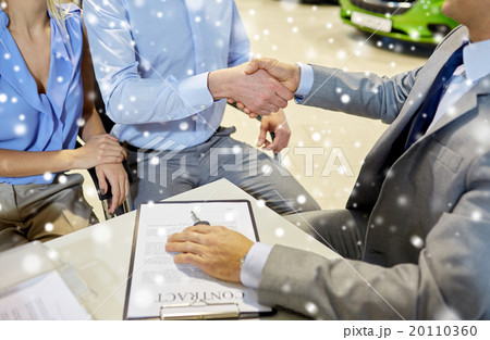 handshake of customer and car dealer in auto salon 20110360