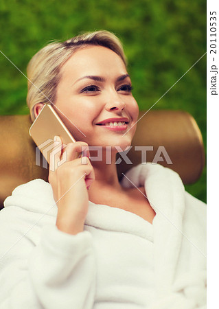 beautiful young woman with smartphone at spa 20110535