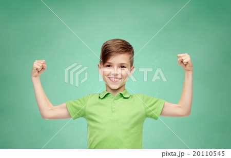 happy boy in polo t-shirt showing strong fists 20110545