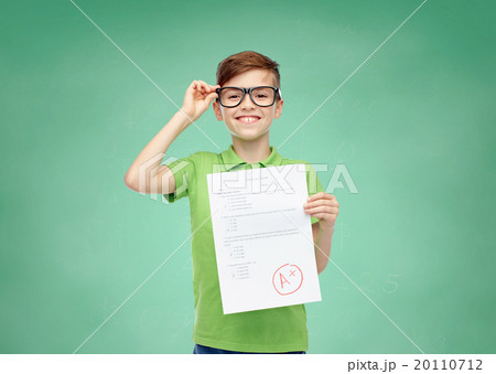 happy boy in eyeglasses holding school test result happy boy in eyeglasses holding school test result 20110712