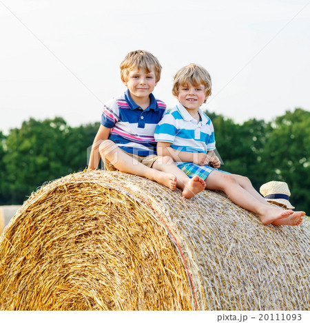 Two little children and friends with hay stack or 20111093