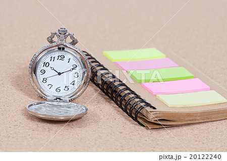 Pocket watch and note book on  background 20122240