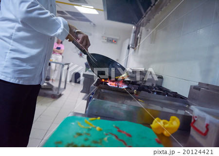 chef in hotel kitchen prepare food with fire 20124421