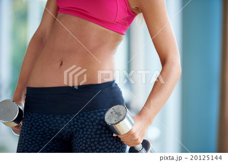 lifting some weights and working on her biceps in a gym 20125144