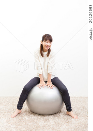 バランスボールに乗る若い女性ポートレート 20126693