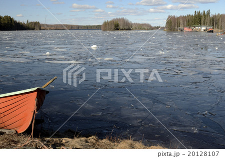 orange rescue boat on the shore of a frozen lake 20128107