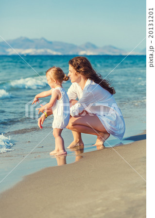 Mother and daughter playing on the beach Mother and daughter playing on the beach 20131201