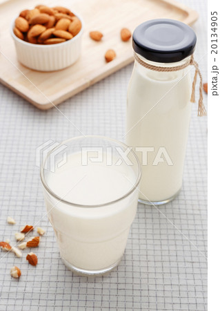 Almond milk in glass and bottle with almonds Almond milk in glass and bottle with almonds 20134905