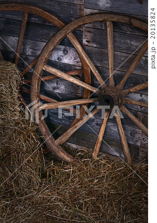 Old wooden wheel on a hay 20135824
