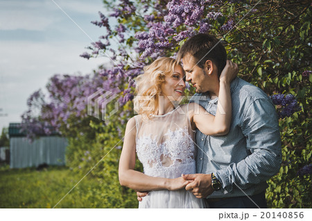 Portraits of a young pair in lilac bushes 3157. Portraits of a young pair in lilac bushes 3157. 20140856