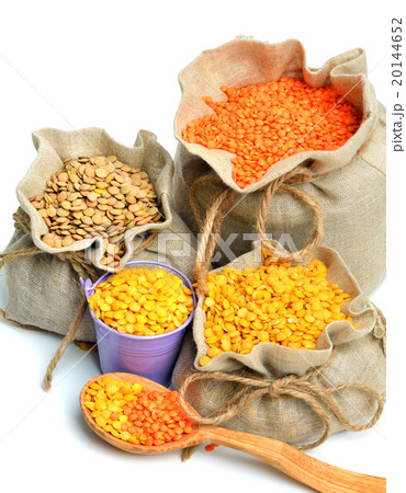 lentils in the sacks and wooden spoon isolated lentils in the sacks and wooden spoon isolated 20144652