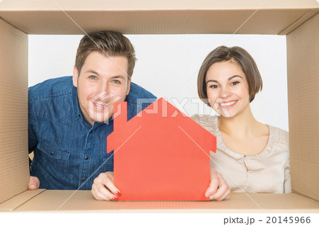Overjoyed couple looking through the box Overjoyed couple looking through the box 20145966