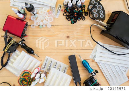 Tattoo machines and equipment on wooden background 20145971