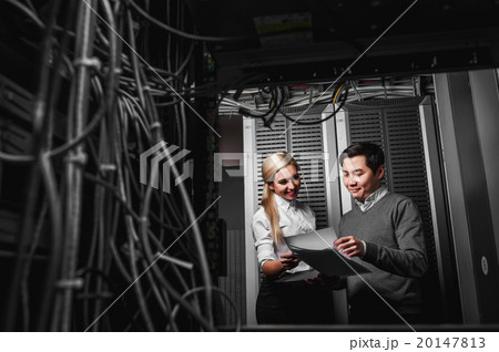 Young engineers businessmen in server room 20147813