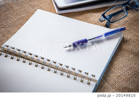 white paper note book page with writing pen lying white paper note book page with writing pen lying 20149810