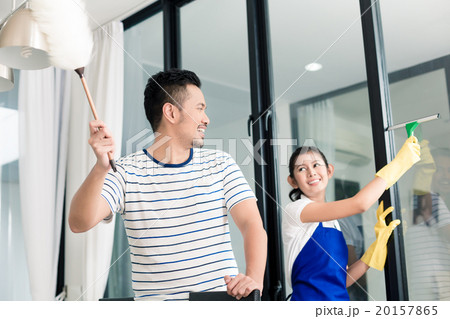 Indonesian couple cleaning their home Indonesian couple cleaning their home 20157865