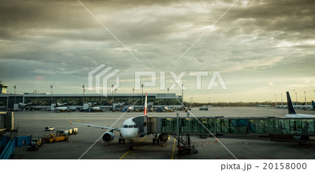 Airplane with passenger boarding bridge at airport gate 20158000