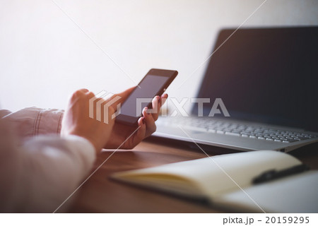 Woman using mobile phone in office workplace Woman using mobile phone in office workplace 20159295