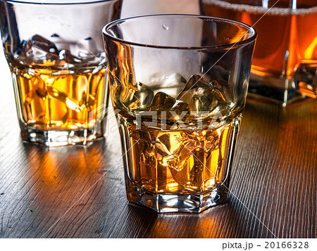 Whiskey on the rocks on a wooden table Whiskey on the rocks on a wooden table 20166328