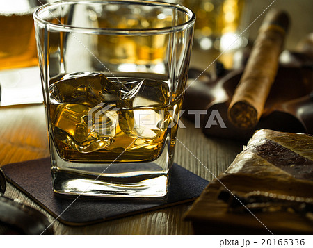 Whiskey on the rocks on a wooden table Whiskey on the rocks on a wooden table 20166336