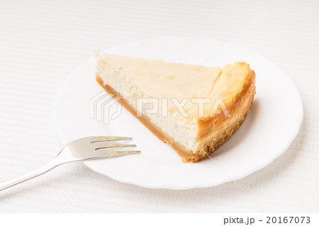 Piece of cheesecake on white saucer 20167073
