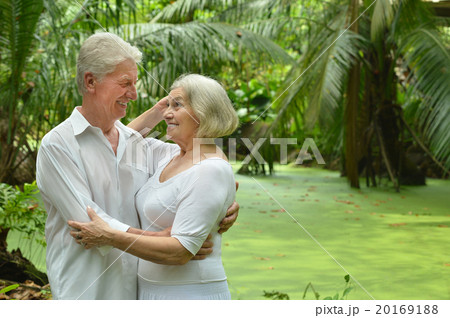 Elderly couple in tropical garden Elderly couple in tropical garden 20169188