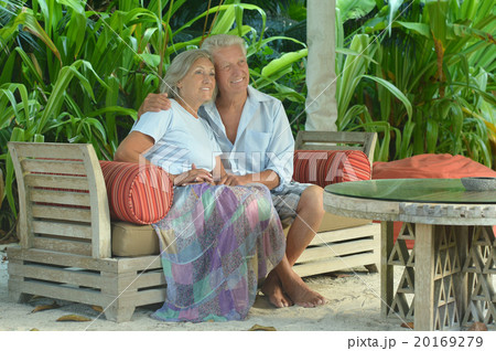Elderly couple  in tropical garden 20169279