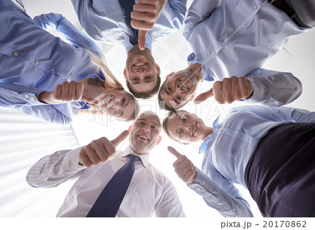 smiling group of businesspeople standing in circle smiling group of businesspeople standing in circle 20170862