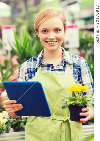 happy woman with tablet pc in greenhouse happy woman with tablet pc in greenhouse 20170917