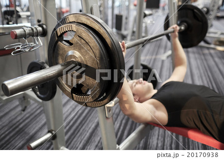 close up of man flexing biceps with barbell in gym 20170938
