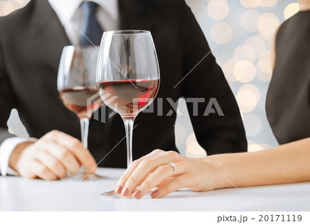 hands of couple with diamond ring and wine glasses 20171119