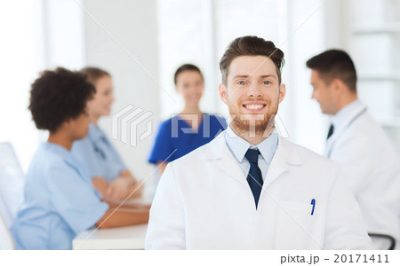 happy doctor over group of medics at hospital 20171411