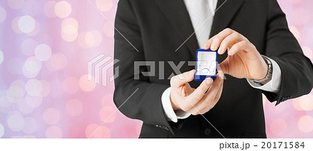 close up of man with gift box and engagement ring 20171584