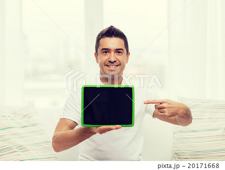 smiling man showing tablet pc blank screen at home 20171668