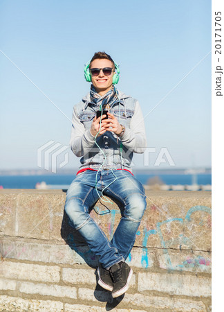 happy young man with tablet pc and headphones 20171705