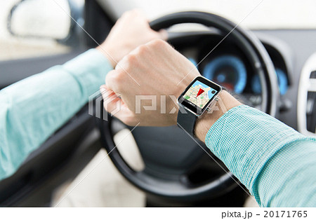 close up of man driving car with gps on smartwatch 20171765