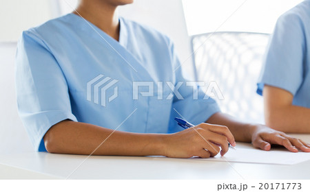 close up of doctor taking notes at hospital close up of doctor taking notes at hospital 20171773