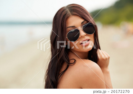 young woman with sunglasses on beach young woman with sunglasses on beach 20172270