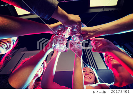 smiling friends with glasses of champagne in club 20172401
