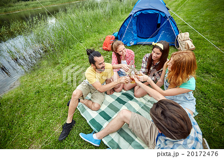 happy friends with tent and drinks at campsite 20172476