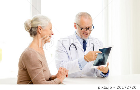 smiling senior woman and doctor with tablet pc 20172720