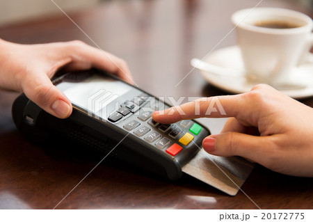 close up of hands with credit card reader at cafe 20172775